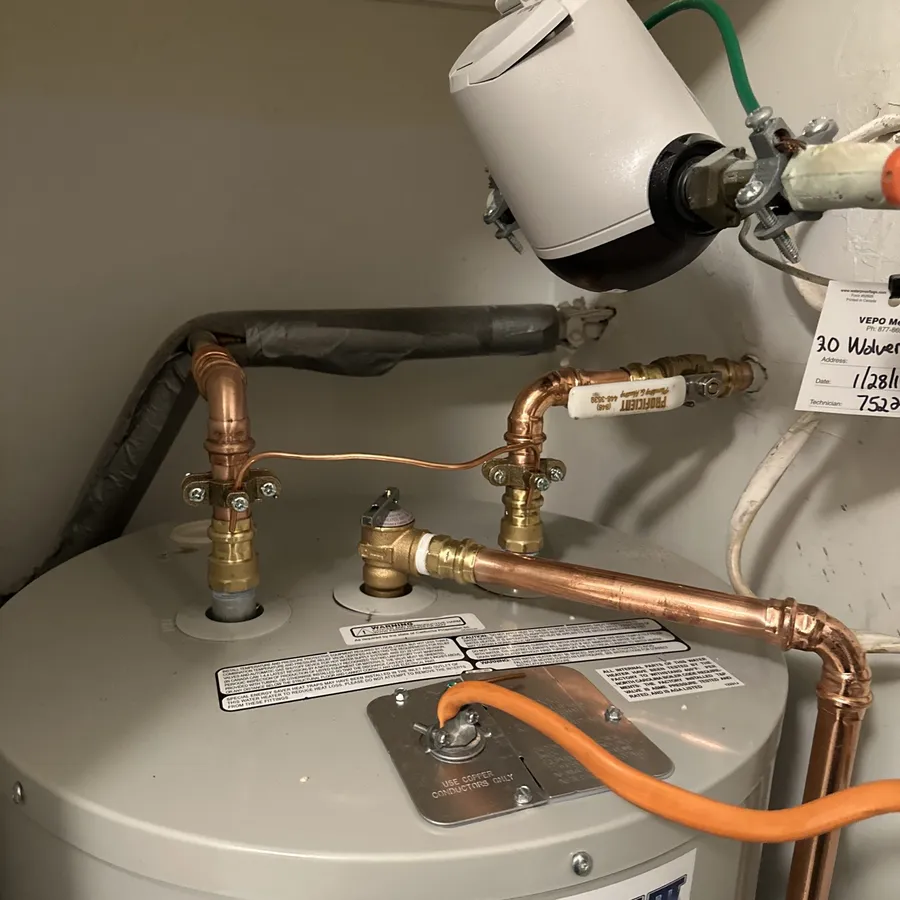 Newly installed water heater with copper piping, Proficient Plumbing branded