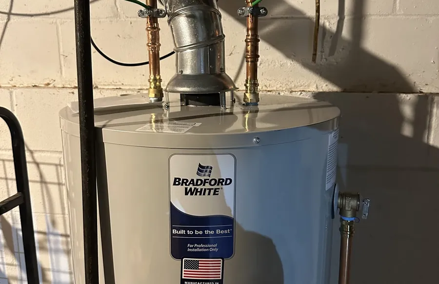 Water heater installation with copper piping and electrical panel
